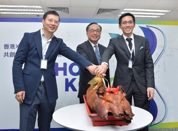 The Secretary for Innovation and Technology, Mr Nicholas W Yang (centre), together with the Chairman of the Hong Kong X-Tech Startup Platform, Mr Neil Shen (left), and the Executive Director of Sun Hung Kai Properties, Mr Christopher Kwok (right), officiate at a roast pig cutting ceremony to celebrate the opening of the Hong Kong X-Tech Startup Platform X-LAB and HQ Office today (December 15).