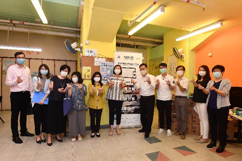 The Secretary for Innovation and Technology, Mr Alfred Sit (fifth right); the Commissioner for Efficiency, Ms Olivia Nip (fifth left); and the Chief Executive Officer of St James' Settlement, Ms Josephine Lee (centre), join a group photo after distributing food packs at the Hong Kong Chinese Church of Christ Grace Elderly Activity Centre today (July 7).