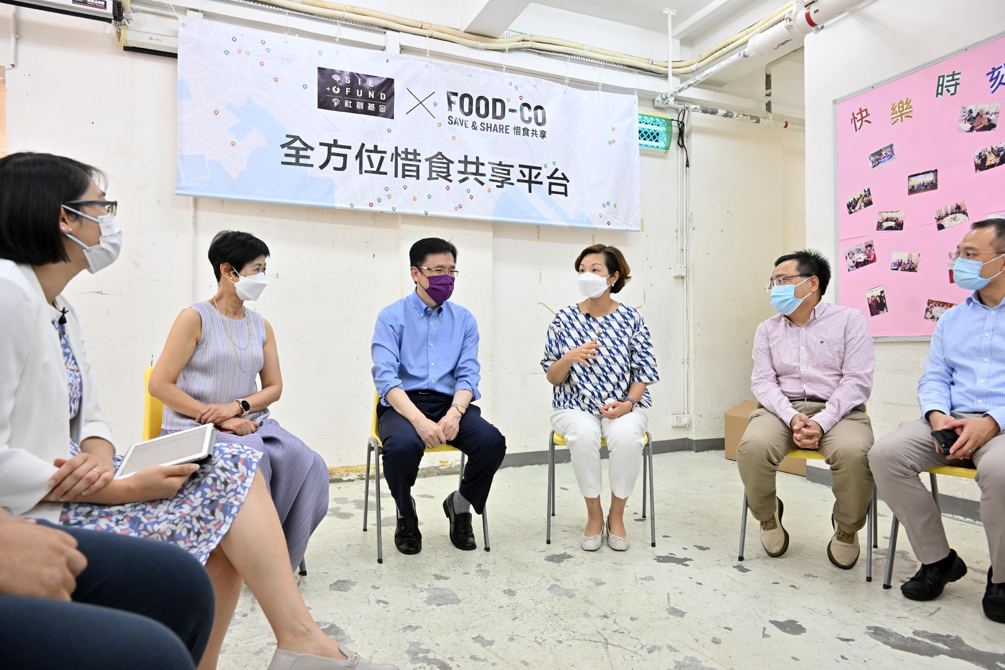 The Secretary for Innovation, Technology and Industry, Professor Sun Dong, today (September 9) visits the Kindness Centre of St James' Settlement, an intermediary of the food support flagship project FOOD-CO launched under the Social Innovation and Entrepreneurship Development Fund (SIE Fund). Photo shows Professor Sun (third left) receiving a briefing from the Chief Executive Officer of St James' Settlement, Ms Josephine Lee (third right), on the latest operation of the food support programme. Looking on are the Commissioner for Efficiency, Mr Ivan Lee (second right); the Chairperson of the SIE Fund Task Force, Dr Jane Lee (second left); and the Vice-chairperson of the SIE Fund Task Force, Mr Alvin Miu (first right).
