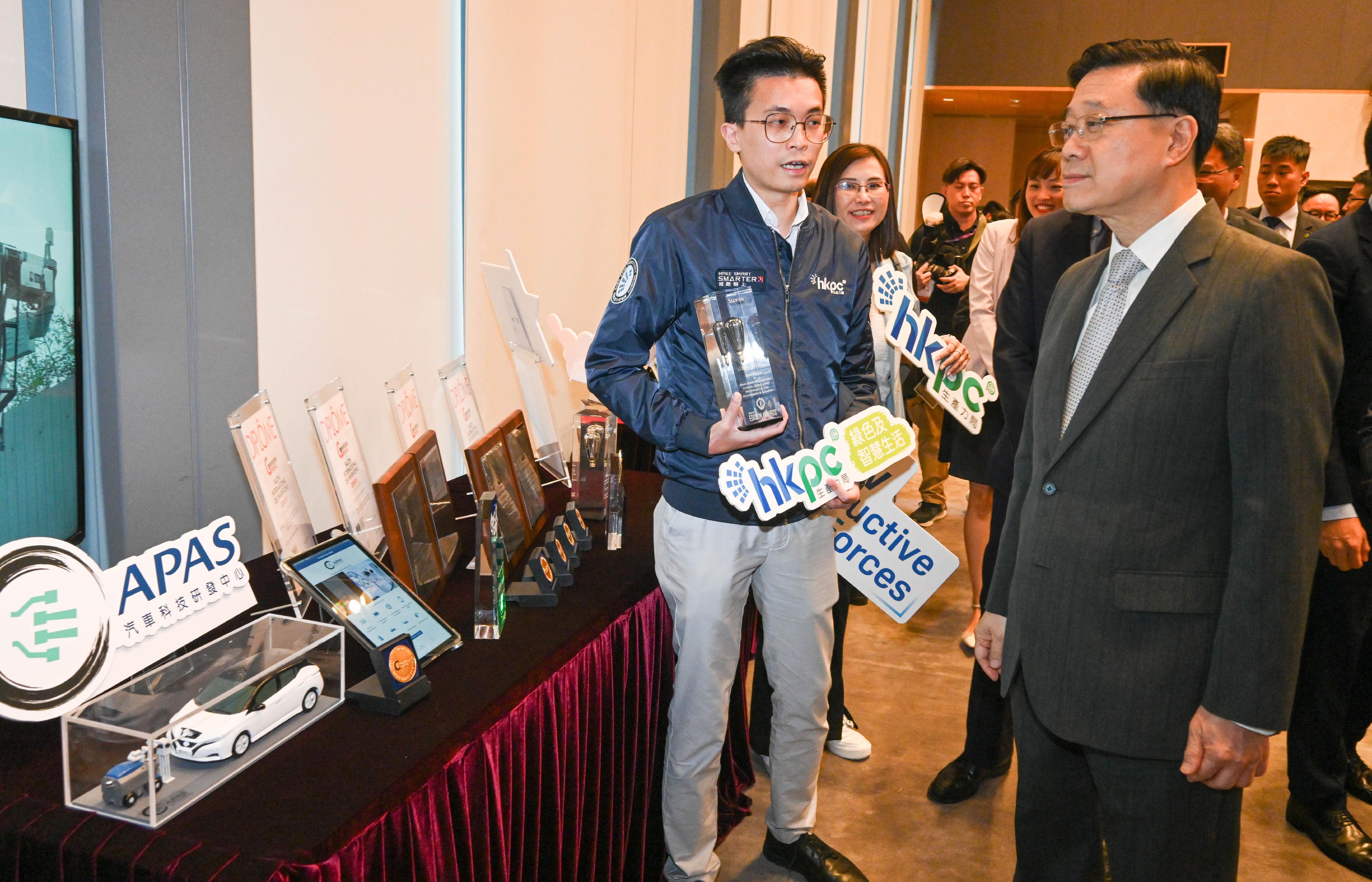 The Chief Executive, Mr John Lee, attended the Reception for I&T Awards 2024 today (July 15). Photo shows Mr Lee (first right) touring the winning projects showcase.
