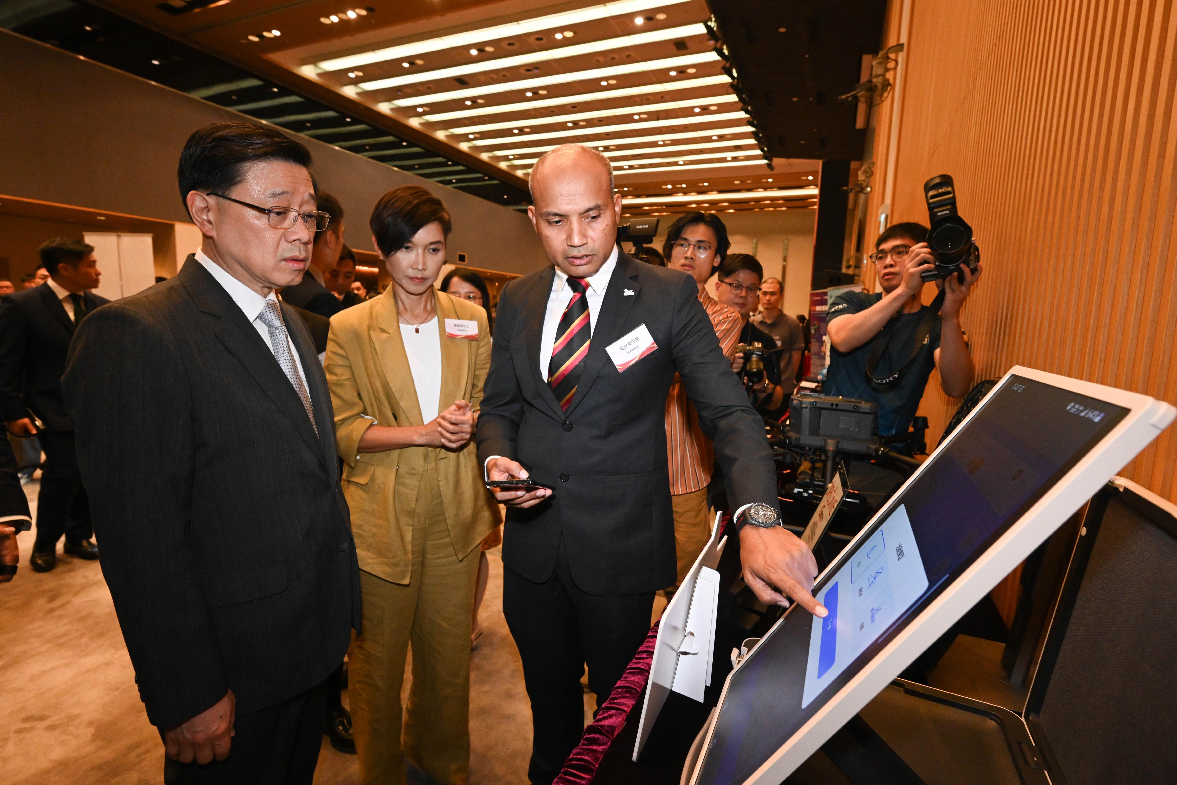 The Chief Executive, Mr John Lee, attended the Reception for I&T Awards 2024 today (July 15). Photo shows Mr Lee (first left) touring the winning projects showcase.
