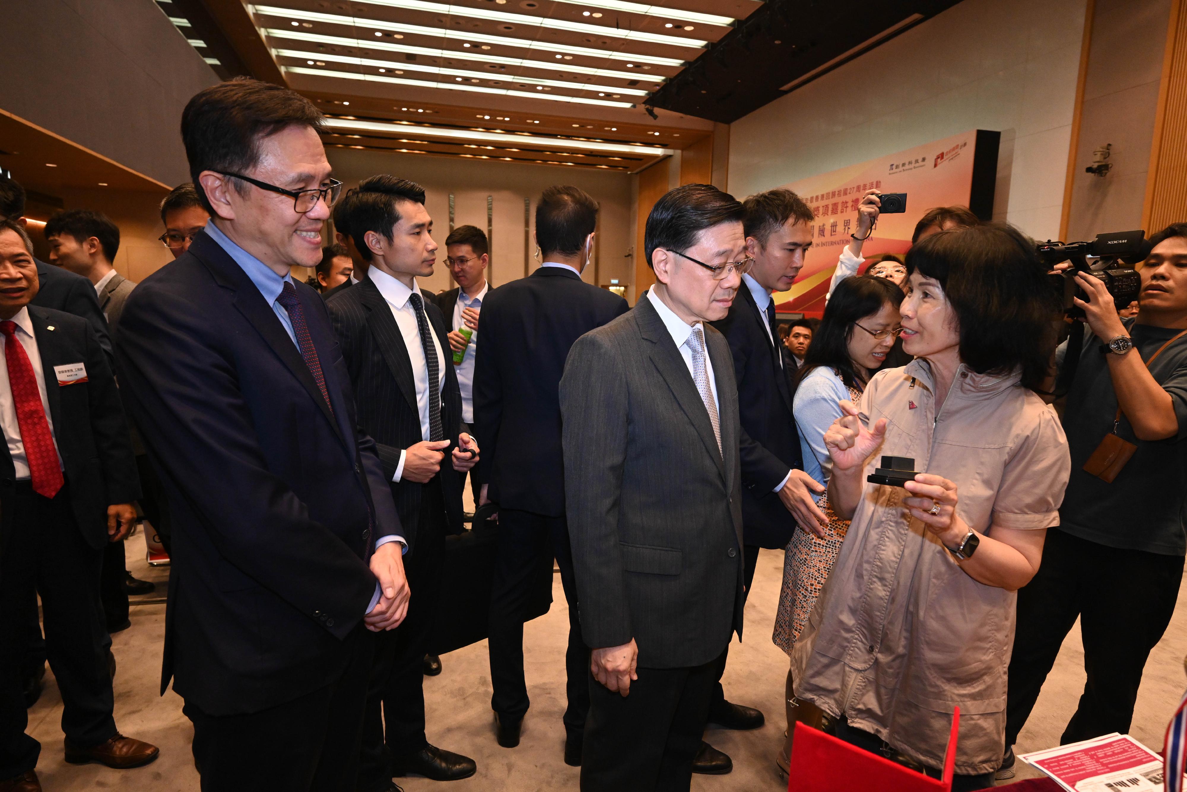 The Chief Executive, Mr John Lee, attended the Reception for I&T Awards 2024 today (July 15). Photo shows Mr Lee (front row, second left) touring the winning projects showcase. Looking on is the Secretary for Innovation, Technology and Industry, Professor Sun Dong  (front row, first left).
